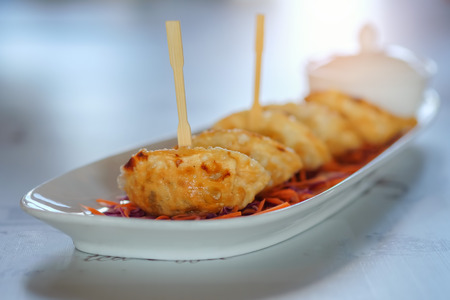 Dumplings fried in white dish on table.の写真素材
