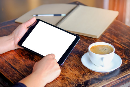 Business people working tablet with coffee and notebook on tableの写真素材