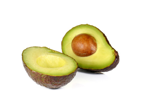 Avocado dark brown cut half isolated on white background.の写真素材