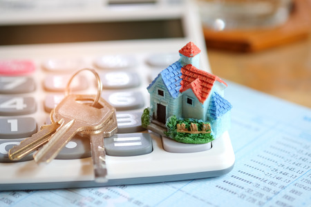 Concept,House model and key with on calculator with book bank.の写真素材