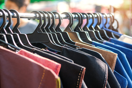 Shirts made of cotton on a hanger on the local market.の写真素材