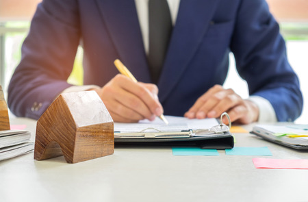 Concept home purchase contract,Businessmen are signing a house purchase contract,The concept of selling a home is signing a contract.の写真素材