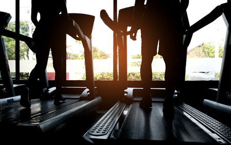 People are running on the treadmill,Silhouette shot from the back.の写真素材