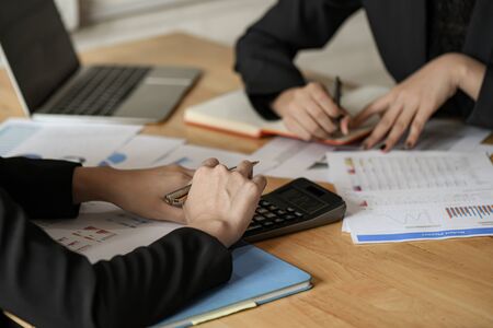 Team businesswomen  use pen, calculator are planning a marketing plan to improve work quality of...