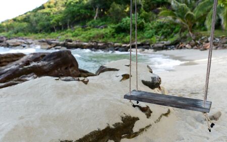 Summer travel concept,Swing over sands beach with island background.の写真素材
