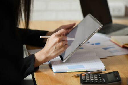 Female executives are using a recording pen on the tablet.の写真素材