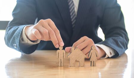 House trading concept The family planner presents the house buying plan.He captured the mannequins model and model house.の写真素材
