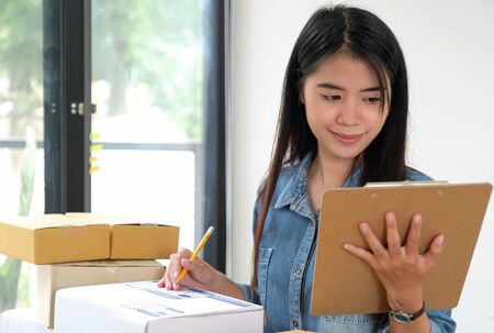 Female staff holding files in hand checking the package.