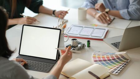 Graphic designer team uses laptops to design new projects for customers.