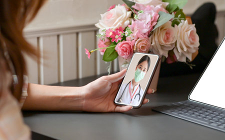 Cropped shot of A Young woman stay at home, she is using a smartphone to video calls consult with a...