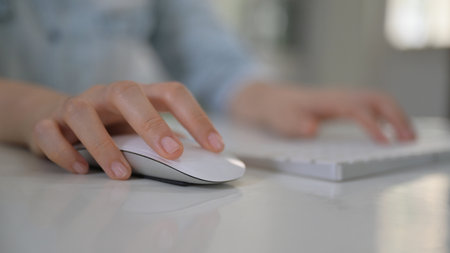 Close up shot Woman hand using mouse and computer keyboard.