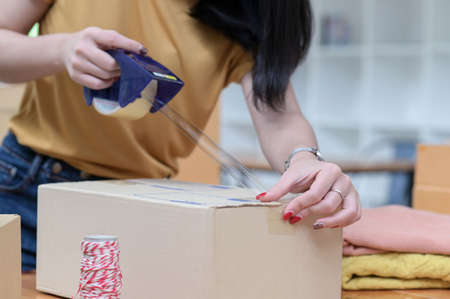Selling products online, packing, transporting parcels, to deliver to customers.の写真素材