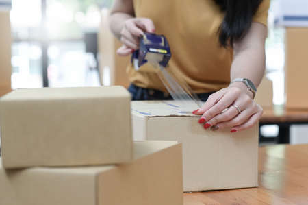 Selling products online, packing, transporting parcels, to deliver to customers.の写真素材