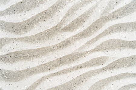 Abstract beachscape, featuring white clean textured sand as the focal point with a top view, background for various design projects.の素材