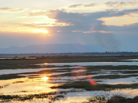 Clouds and sky at sunset, water reflectionの写真素材
