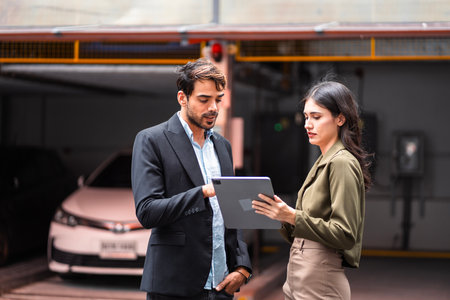 Car salesman talking to male customerの写真素材