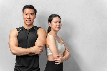 Asian men and women Have a strong body, good health, love to exercise. They are exercising together at the gym having fun.の写真素材