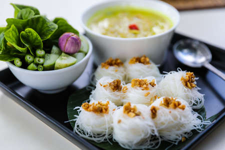 Rice noodle in fish curry sauce, famous native Thai style with vegetable - Thai food called Kanoom Jeen Nam Ya.の写真素材