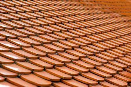 Close-up of red roof tiles patterns. Roofing building and construction.の写真素材