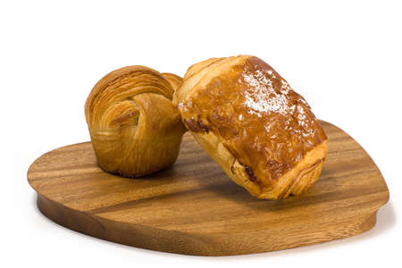 Close-up Pain Au Chocolate Freshly backed homemade traditional chocolate croissant. On the wooden tray white background.の写真素材