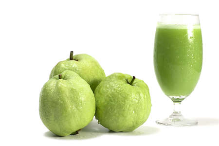 Fresh of Guava fruit and a Glass of Guava juice, with drops of water on glasses. Organic health drinks on white background.の写真素材