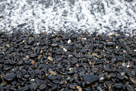 Abstract background of nature black, white, smooth wet stones and Pebble, on the beach.の写真素材