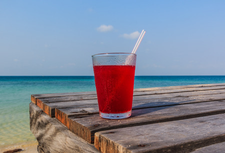 Strawberry juice on Wooden pathway near the beachの写真素材