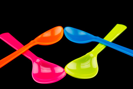 Plastic spoons on black backgroundの写真素材