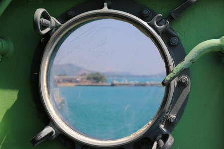 Steel porthole of warshipの写真素材