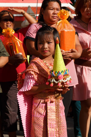 ROYONG , THAILAND - JULY 6    Unidentified Thai girl carry offering in hand at Wat Baan Don in Ordination Ceremony of a monk  on JULY 6  , 2014 in Rayong , Thailand のeditorial素材