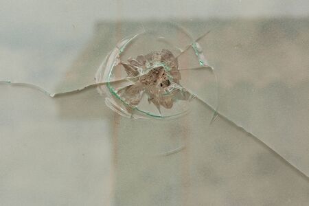shattered glass with a hole in it