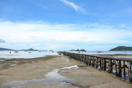 old wood pier of fishing village in nature when water run downの写真素材