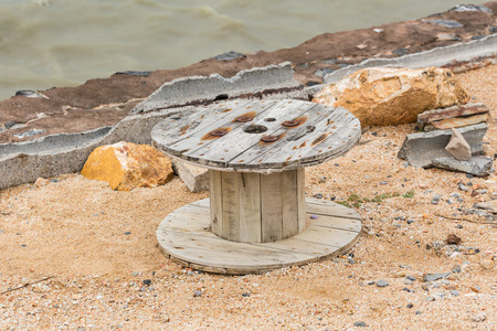 Big old wooden roll on rock coastal beachの写真素材