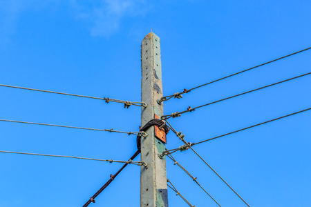 electricity post against blue sky background