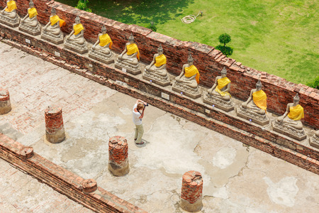 AYUTTHAYA, THAILAND- AUGUST 8 : The Photographer and raw of Buddha statue in Wat Yaichaimongkol Buddhist temple in the city of Ayutthaya Historical Park at Ayutthaya,Thailand on August 8, 2015のeditorial素材