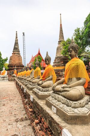 AYUTTHAYA, THAILAND- AUGUST 13 : The row of Buddha statue in Wat Yaichaimongkol Buddhist temple in the city of Ayutthaya Historical Park at Ayutthaya,Thailand on August 13, 2015のeditorial素材