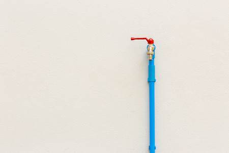Faucet on cement wall