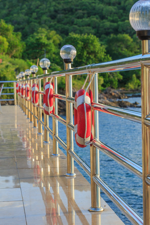 Rows of stainless fences  and Red lifebuoyの写真素材