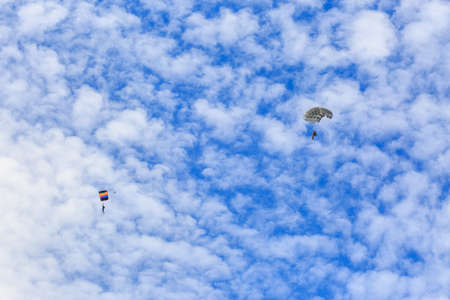SATTAHIP , THAILAND â SEPTEMBER 11 , 2015 : The parachutist descends and trains in landing accuracy that parachute fly on blue sky with white cloud in day in Sattahip ,  Thailand on September 11 ,2015のeditorial素材