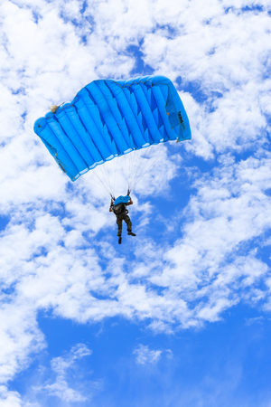 SATTAHIP , THAILAND - SEPTEMBER 23 , 2015 : The parachutist descends and trains in landing accuracy that parachute fly on blue sky with white cloud in day in Sattahip ,  Thailand on September 23 ,2015のeditorial素材