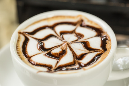 Latte art in white cupの写真素材