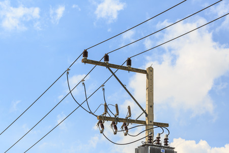 electricity post against blue skyの写真素材