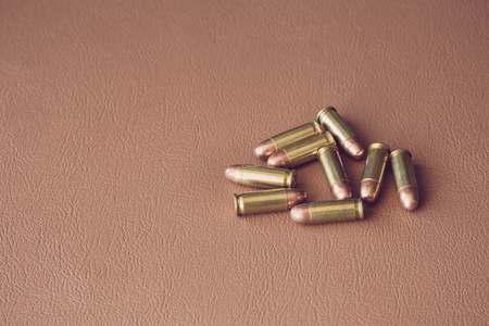 Nine bullets on brown leatherの写真素材