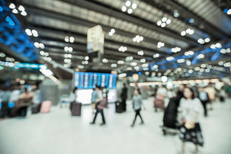 Blurred background : Traveler at airport terminal blur background with bokeh lightの写真素材