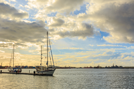 PAPEETE, FRENCH POLYNESIA - OCTOBER 27, 2016 :  The sailing boat park in sunset time at Large seaport in Tahiti PAPEETE, FRENCH POLYNESIA.のeditorial素材