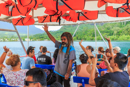 PAPEETE, FRENCH POLYNESIA - OCTOBER 28, 2016 : Tahitian instructor guiding tourists on boat in the...