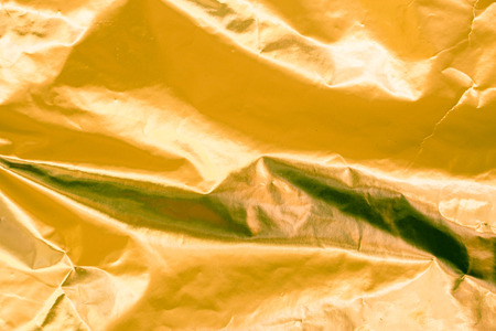Closeup of yellow wrinkled paper texture backgroundの写真素材