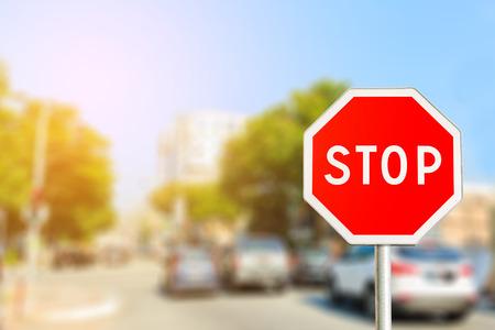 Stop sign by the City road with light effectの写真素材