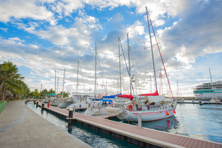 PAPEETE, FRENCH POLYNESIA - JUNE 30, 2018 : The sailing boat park in sunset time at Large seaport in Tahiti PAPEETE, FRENCH POLYNESIA.のeditorial素材