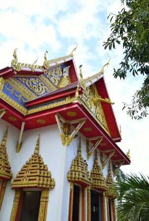 thai tample under sky  filled with clouds の写真素材